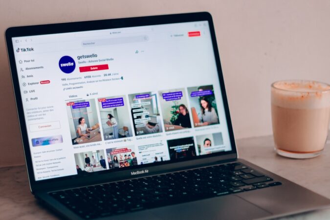 a laptop computer sitting on top of a table next to a cup of coffee